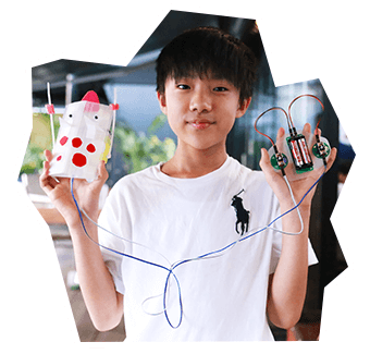 A boy with an original robot made with create-a-critter robot kit